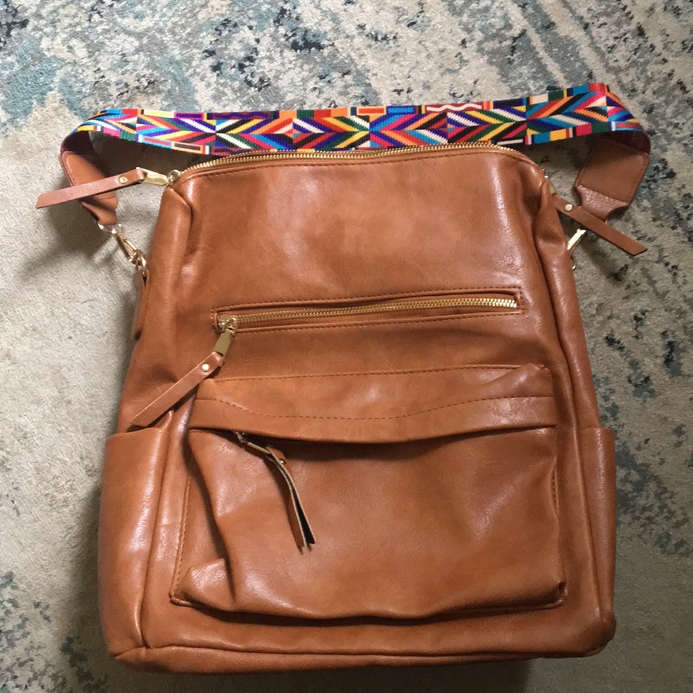 Brown faux leather boho backpack with strap.